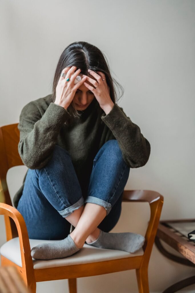 Person sitting thoughtfully, representing reflection and stress relief in therapy