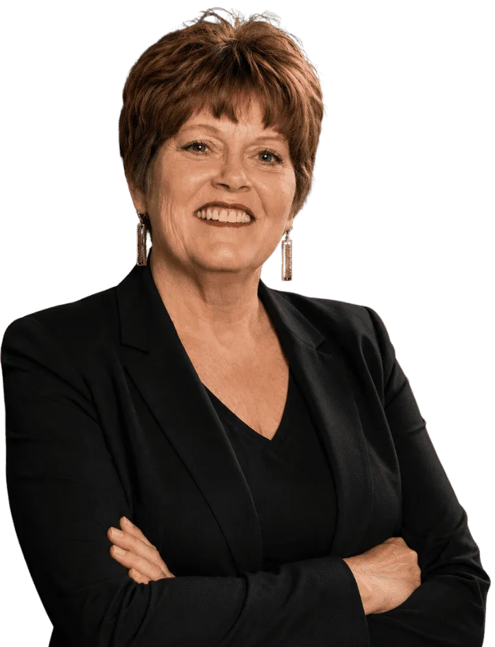 Peggy Dunn, founder of Dunn's Counseling Services, smiling with arms crossed in professional attire