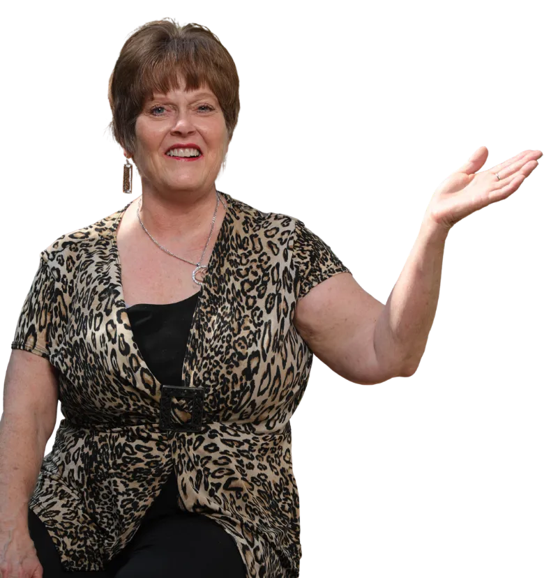 Peggy Dunn, founder of Dunn's Counseling Services, smiling and gesturing to the side
